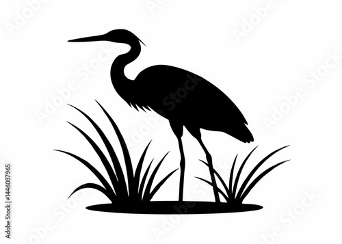 Black heron silhouette standing in a marsh with tall grass