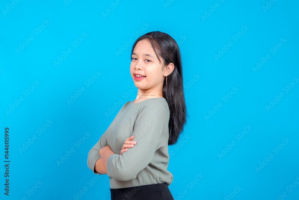 A young woman with crossed arms offers a friendly, slightly coy smile while glancing to the side. Her warm expression and indirect gaze create a sense of gentle charm and approachability. A young woman with crossed arms offers a friendly, slightly coy smile while glancing to the side. Her warm expression and indirect gaze create a sense of gentle charm and approachability.