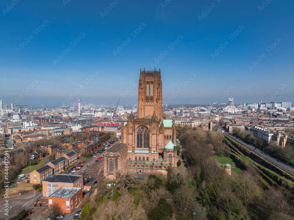 Aerial view of Liverpool highlighting the Gothic Revival Liverpool Cathedral, tree lined streets, residential areas, and the distant waterfront.