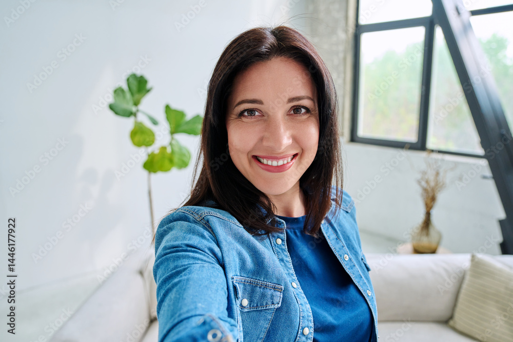 Selfie portrait happy beautiful woman in home interior