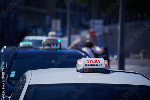 French Marseilles Taxi sign close-up view with the street view with the unfocused depth of field background
