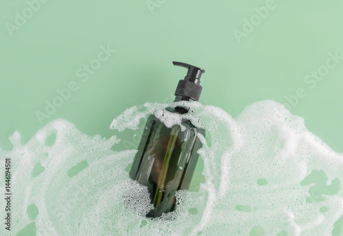 Elegant shower gel bottle surrounded by frothy bubbles