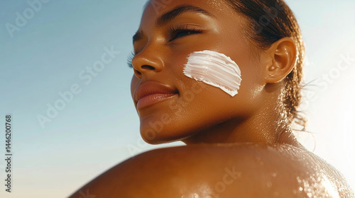 Woman applying sunscreen outdoors