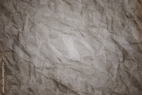 A sheet of old gray wrinkled paper texture as background