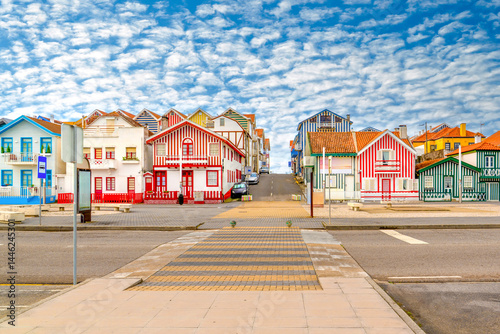 Colorful striped houses called Palheiros with red, blue and green stripes. Costa Nova do Prado is a beach village resort on Atlantic coast near Aveiro, Portugal