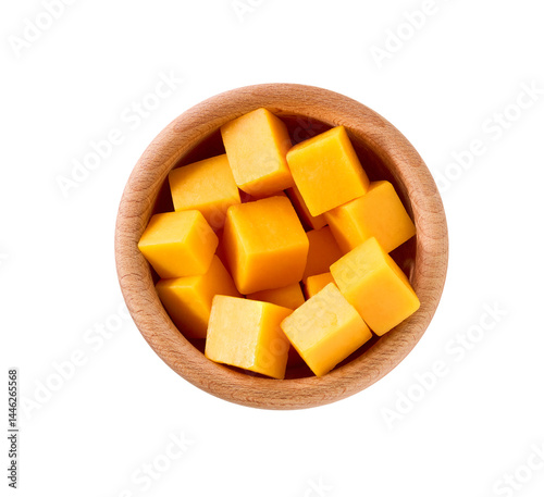 cheddar cheese sliced ​​into cubes in a wooden bowl isolated on a white background, top view.