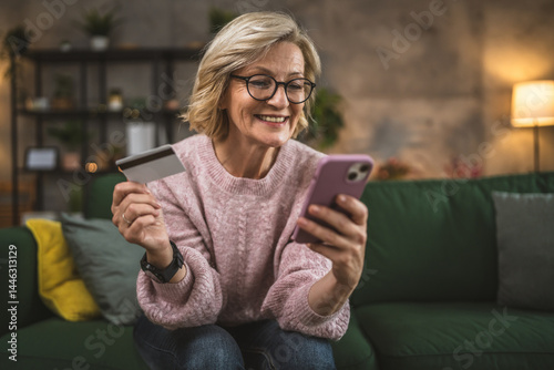 Wallpaper Mural mature woman caucasian female hold credit card online shopping at home Torontodigital.ca