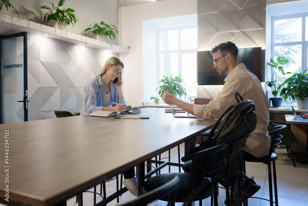 A teamwork session taking place in a professional workspace with greenery and light. A teamwork session taking place in a professional workspace with greenery and light.