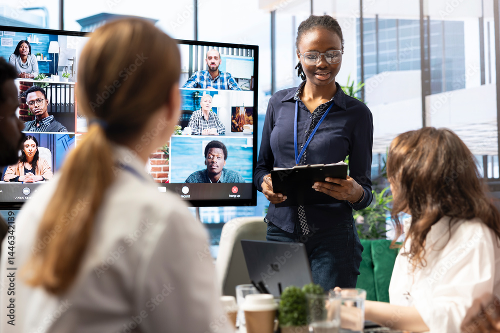 Diverse team of workers reviewing project updates together with shareholders on video call online meeting, ensuring easy remote collaboration for global business expansion plans. Teamwork.
