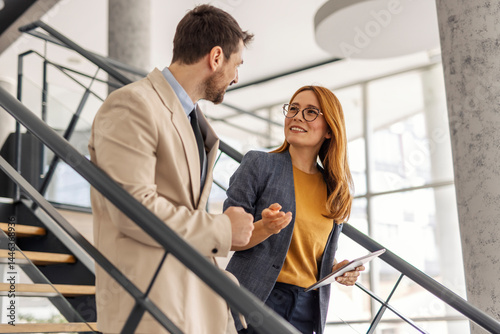 Businesspeople walking on staircase at enterprise and discussing business strategy,