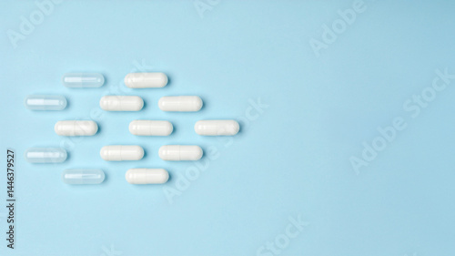 Obraz na płótnie Placebo, Active, and Empty Capsules on Blue – Medical Comparison Concept w salonie