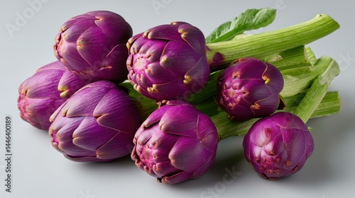 A vibrant array of fresh, organic artichokes showcases their unique hues and textures in a topdown view.