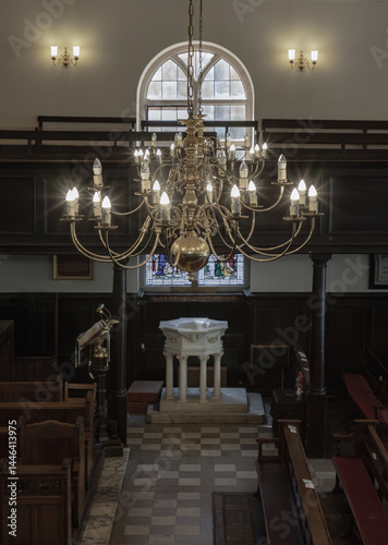 Obraz na płótnie Stunning view of Chandelier hanging from the ceiling over white octagonal baptismal font inside of The Church of King Charles the Martyr, is a Church of England parish church in Royal Tunbridge Wells. w salonie