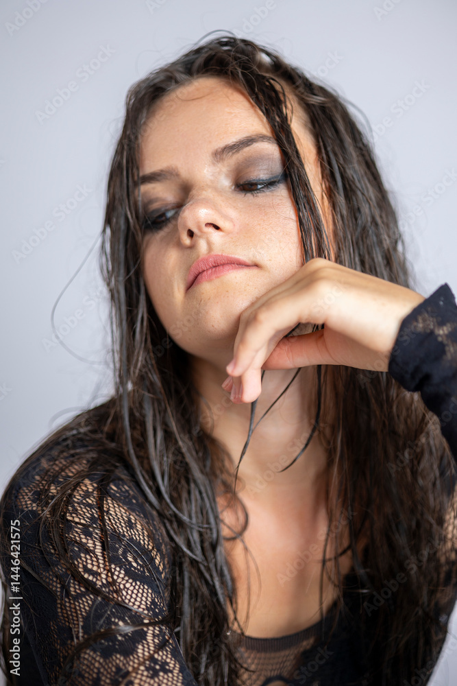 Obraz premium Young women posing with wet hair and black transparent bodysuit.