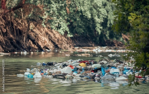 A river with a significant amount of trash and plastic waste