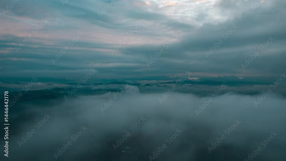 Breathtaking aerial timelapse of atmospheric clouds over a mountainous landscape during twilight Breathtaking aerial timelapse of atmospheric clouds over a mountainous landscape during twilight