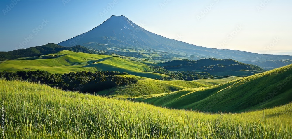Fototapeta premium Majestic Mountain Over Rolling Green Hills Under Blue Sky