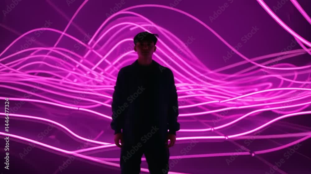 Young person standing against vibrant purple light waves in a modern artistic space, creating a dynamic atmosphere Young person standing against vibrant purple light waves in a modern artistic space, creating a dynamic atmosphere