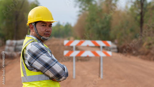 Obraz na płótnie Road Construction Observer: A dedicated road construction worker stands with watchful gaze, embodying the essence of safety and expertise amidst the ongoing construction project. w salonie
