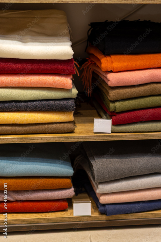 Colorful stacks of neatly arranged fabrics in a cozy textile shop during a quiet afternoon Colorful stacks of neatly arranged fabrics in a cozy textile shop during a quiet afternoon