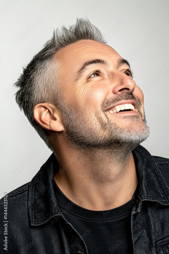 Obraz premium Trendy men's short punk haircut - midlife white man with grey hair. A proud and confident gentleman standing tall. Creative of style for aging men. Pure white solid background.