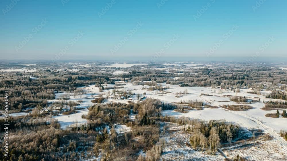 Breathtaking aerial panorama of snowy countryside and frosted forest landscape at winter sunrise. Drone winter hyperlapse. Clean environment.