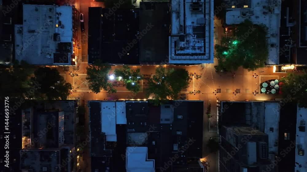 Warm lighting lantern of shopping city street at night. Aerial top down shot. Rooftops of houses, homes and shops in Charlottesville, Virginia.