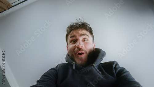 Young Boy Reacting with Amazement While Unboxing a Package from a Low Angle Perspective