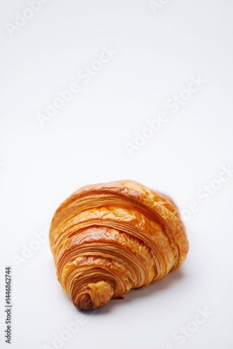Wallpaper Mural A golden-brown croissant with a flaky, spiral texture sits against a plain white background. Torontodigital.ca