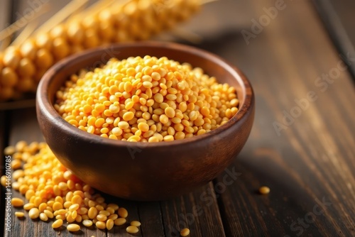 Wooden bowl filled with golden flaxseed on a wooden table, texture, decorative