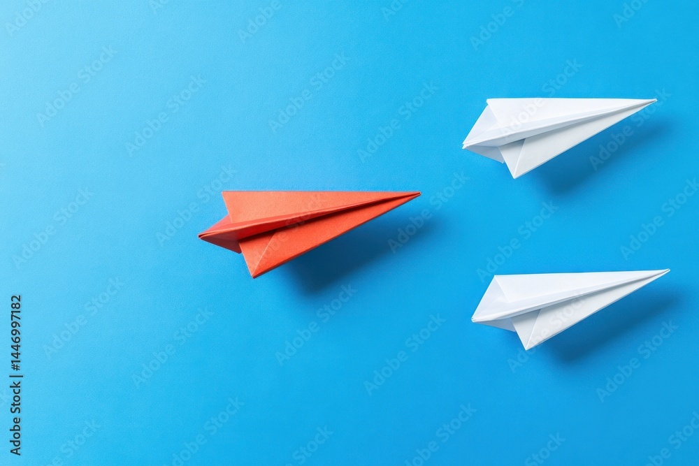 Red paper airplane leading a group of white ones Red paper airplane leading a group of white ones