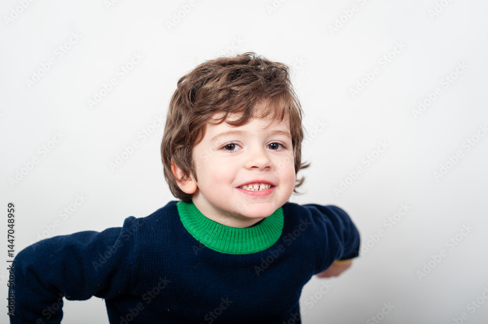 Smiling child in a vibrant sweater indoors Smiling child in a vibrant sweater indoors