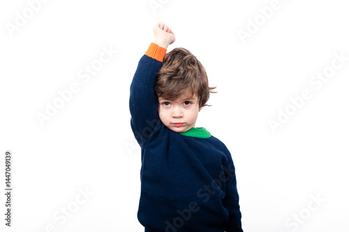 Child raising fist in confident pose