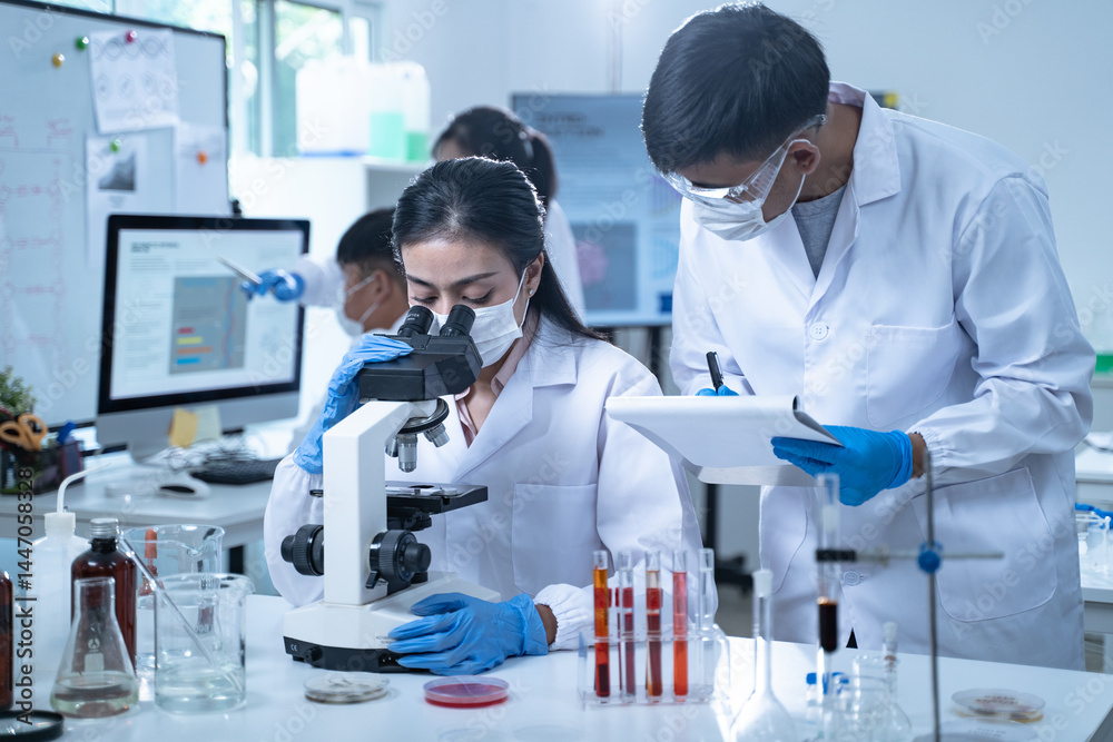In the laboratory, researchers conduct blood tests and chemical analysis, with doctors taking notes and closely examining samples through the microscope for ongoing research. In the laboratory, researchers conduct blood tests and chemical analysis, with doctors taking notes and closely examining samples through the microscope for ongoing research.