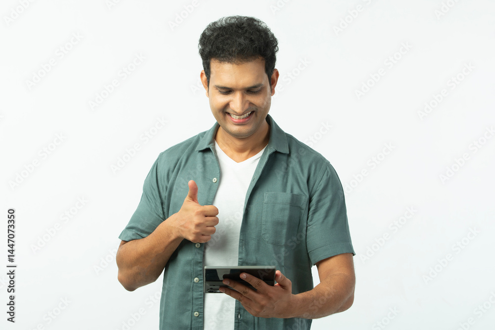 Portrait of Indian Young man using mobile phone and wear casual mint shirt white t-shirt isolated on a white background Portrait of Indian Young man using mobile phone and wear casual mint shirt white t-shirt isolated on a white background