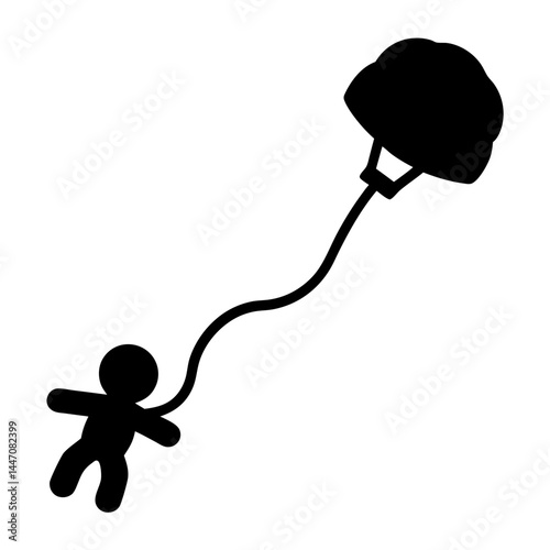 Black silhouette of a person parachuting and floating in mid air