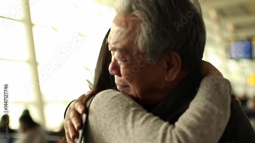 Emotional reunion between daughter and father at airport during farewell