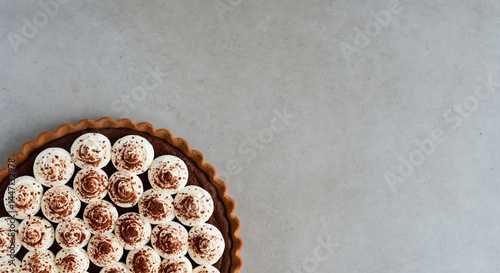 Appetizing Chocolate Chiffon Pie With Cream Topping on Gray Background with Copy Space