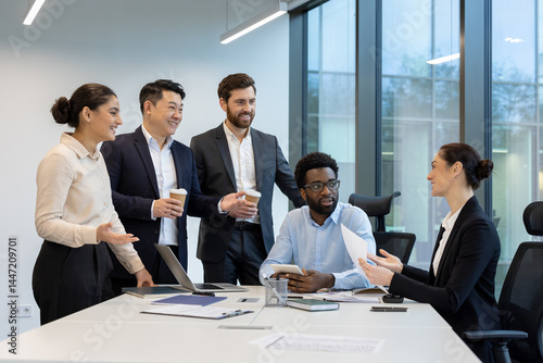A diverse group of business professionals collaborates in a modern office setting, discussing strategies and ideas with documents and a tablet.