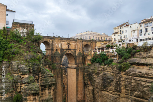 A view of the spectacular gorge and historic bridge, seperating and joining the two parts of Ronda, a famous village in Adalusia, Spain
