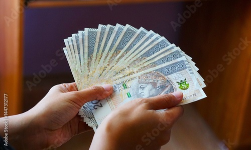 Polskie pieniądze 200 złoty. Gotówka trzymana w dłoni.