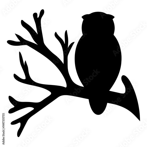Silhouette of an owl perched on a bare tree branch at night