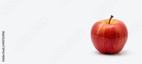 Crimson Delight: A single, vibrant red apple stands in splendid isolation. Its crisp, shiny skin and elegant stem invite a sensory experience of fresh fruit