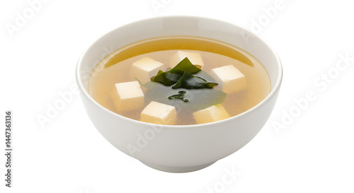 Creamy, light-colored soup in a bowl, featuring tofu cubes and seaweed