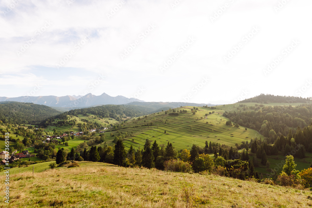 Obraz premium Inspiring landscape of green hills. Terraced fields stretch across the hills of lush greenery. Concept of nature, freedom and view.