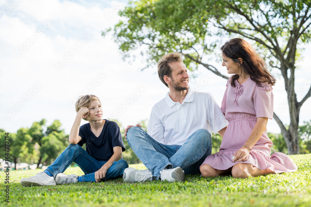 Fototapeta premium Happy family parent children having picnic outdoor activity. Enjoy happiness moment summer playing together including father mother son and daughter relaxing in the morning sunrise.