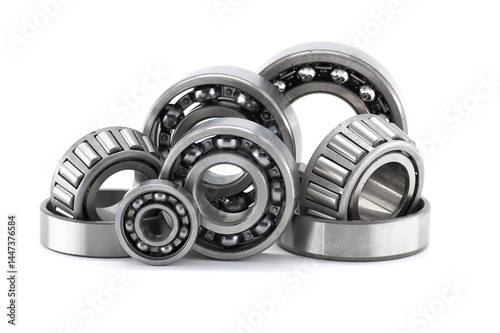Assortment of various bearings isolated on a clean white backdrop, close up details.