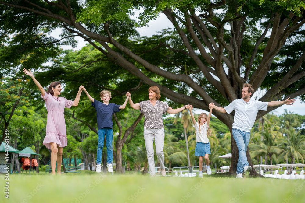 Fototapeta premium Happy family parent children having picnic outdoor activity. Enjoy happiness moment summer playing together including father mother son and daughter relaxing in the morning sunrise.