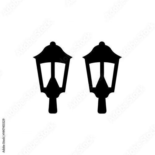 Two black silhouette of street lanterns