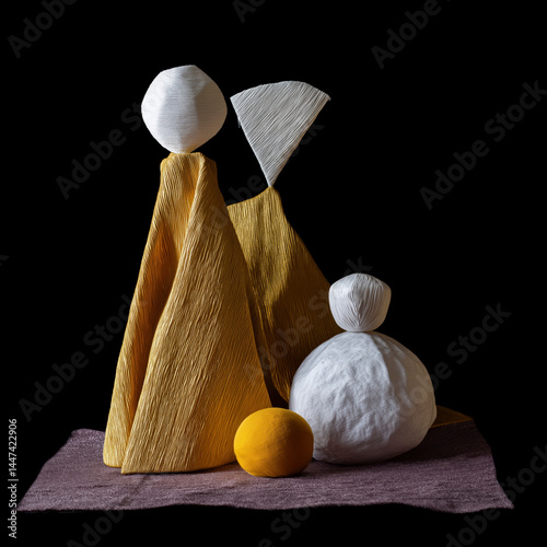 A group of three sculptures are on a table
